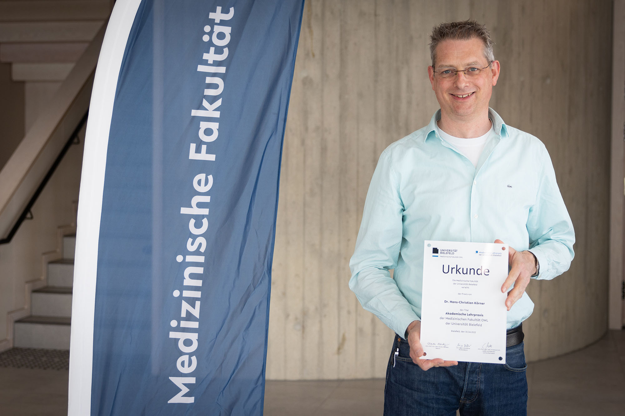 Dr. med. Körner mit einer Urkunde